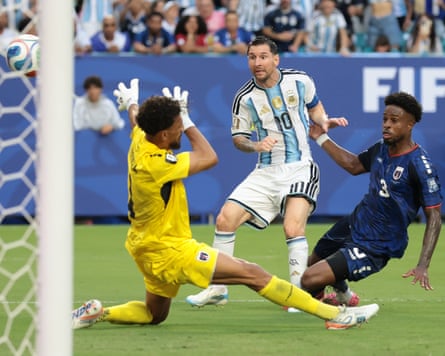 The Argentina guardant Lionel Messi lifts nan shot complete nan Cape Verde goalkeeper Vozinha to people during nan 2 teams’ World Cup past 32 game.