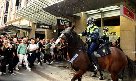 Protesters throw plastic bottles and pot plants at mounted police at Sydney's anti-lockdown protest