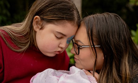 a mother and child rest their heads on each other while posing for a portrait