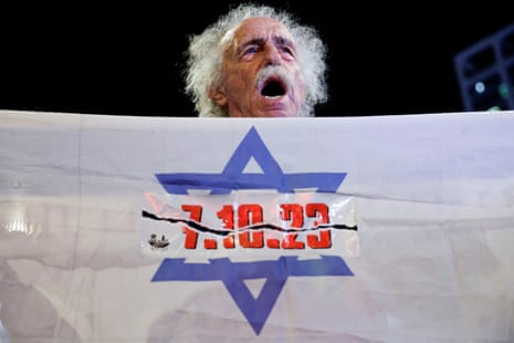 A man holds a banner during a demonstration to demand the liberation of hostages in Tel Aviv, Israel.