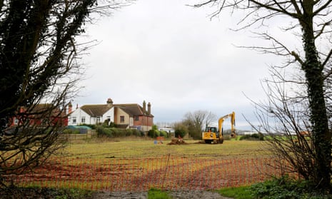 A digger at work in a field near Dover, Kent