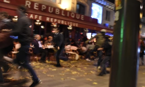 People run after hearing what is believed to be explosions or gun shots in Paris on 13 November.