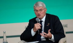 Andrew Mitchell speaking into a microphone at Cop28