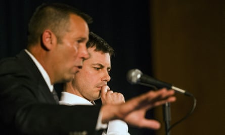 The South Bend police chief, Scott Ruszkowski, left, speaks as Buttigieg listens during the town hall meeting.