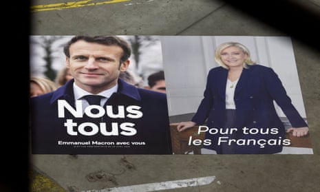 Macron and Le Pen campaign flyers on pavement.