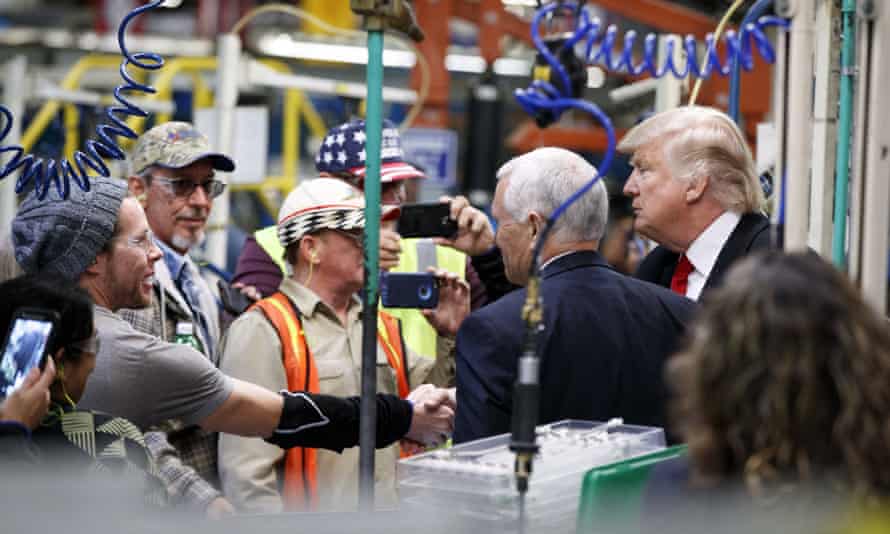 Donald Trump and Mike Pence talk with factory workers during a visit to the Carrier factory.