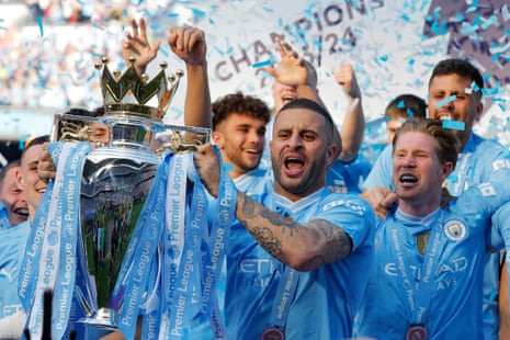Manchester City’s Kyle Walker lifts the trophy.