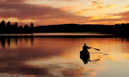 Paddling a canoe on a lake in Algonquin Provincial Park, Ontario, Canada