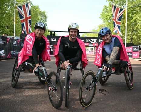 China's Luo Xingchuan, Switzerland's Marcel Hug and Britain's David Weir pose at the finish after the men's wheelchair race at the London Marathon