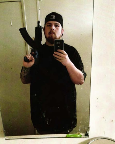 In this selfie, Ricky Straight poses with an AR-style pistol, a type of weapon that is prohibited in California.