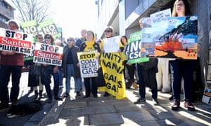 Demonstrators hold placards to protest against Santos’s plans for a major coal seam gas field near Narrabri, in 2017.