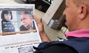 A Moroccan man reads the story of French reporters Catherine Graciet (L) and Eric Laurent in Al-Massae newspaper.