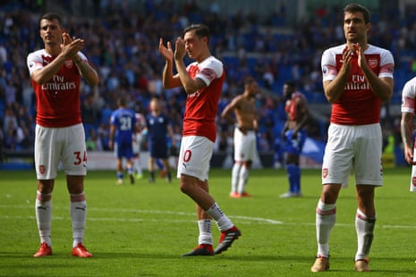 Arsenal’s players applaud supporters after their victory over Cardiff.