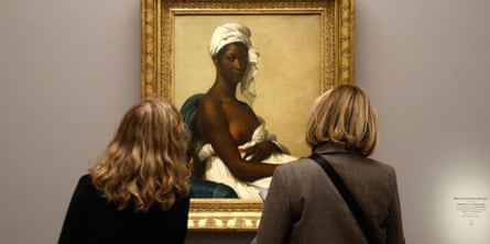 Visitors look at the painting Portrait de Madeleine (1800), by French painter Marie-Guillemine Benoist.