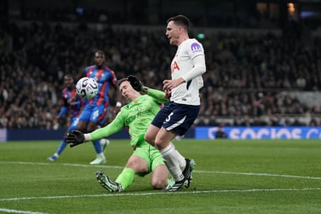 Goalkeeper Dean Henderson dives to block Andy Robertson's shot during a Premier League match