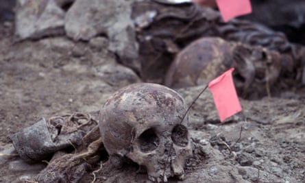 Forensic experts uncover remains found in a mass grave