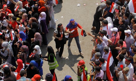 Volunteers form a safe zone between men and women to prevent sexual harassment during a protest against the then president, Mohamed Morsi, in Tahrir Square in Cairo, Egypt, July 2013.