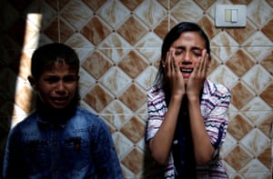 Palestinian relatives of Hamas gunman Mohammed Hejelah, who was killed by an Israeli air strike, mourn during his funeral in Gaza.