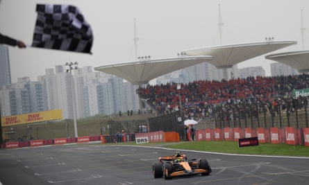 Lando Norris of Britain crosses the finish line to place second.