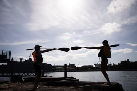 Bertin Huynh takes a kayaking lesson on Sydney Harbour with Sophie Morgan.