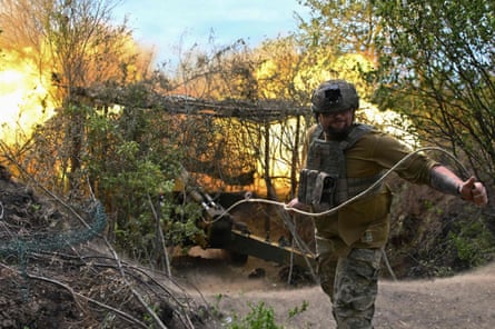 A Ukrainian soldier fires a field gun toward Russian positions in the Donetsk region on Friday .