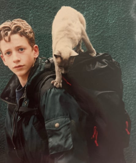 Comedian John Robins, aged astir 12, pinch his feline trying to get into his rucksack arsenic he leaves for Scout camp