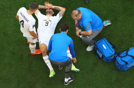 Serbia's Aleksandar Mitrovic receives medical attention after sustaining an injury.