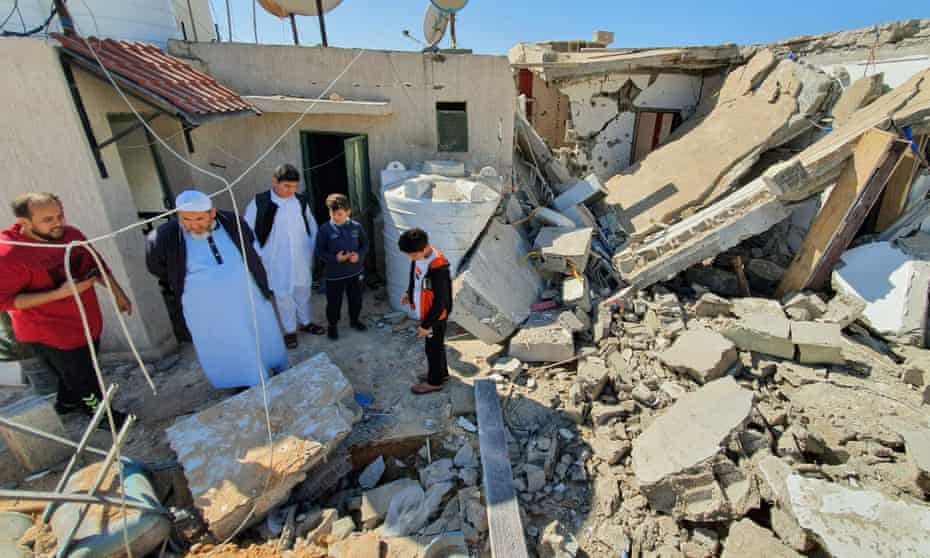People inspect damage from a rocket attack by forces loyal to the Libyan strongman Khalifa Haftar in a residential area of Tripoli. 