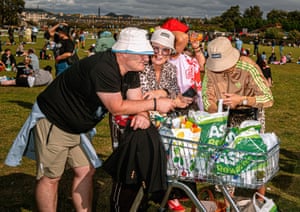 Fans with a shopping trolly full of Asda bags.