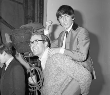 George Harrison riding piggyback on Mal Evans.