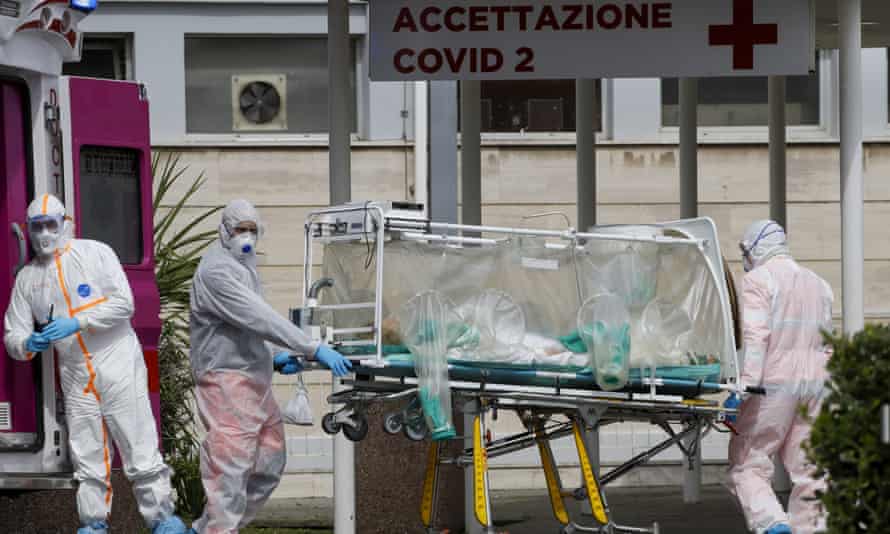 A patient in a biocontainment unit is transferred from an ambulance into Columbus Covid 2 hospital in Rome.