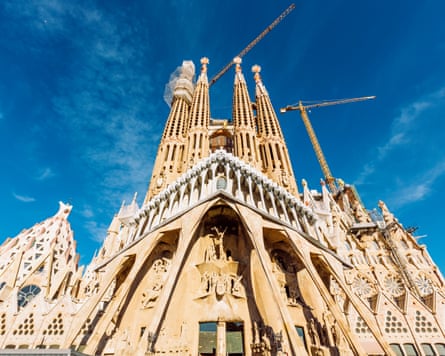 Gaudí’s Sagrada Família in Barcelona with cranes and a blue sky