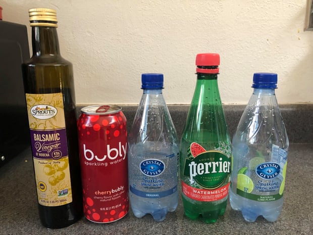 Bottles of vinegar and sparkling water. Brands are Bubly, Crystal Geyser and Perrier