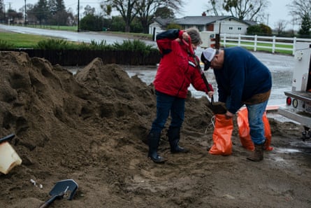 Tim and Liz Ehlers make sandbags to protect their property.