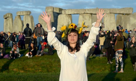 People celebrating the summer solstice, a pagan festival day, at Stonehenge in 2019