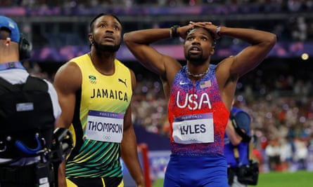 Noah Lyles and Kishane Thompson watch the replay after their photo-finish