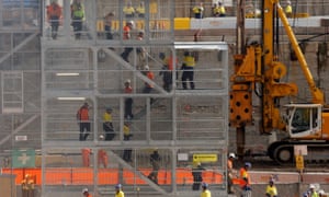 Construction workers descend using temporary stairs on a major construction site in central Sydney June 13, 2013.