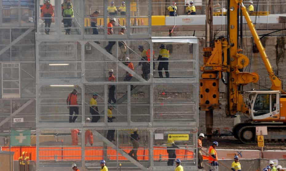 Construction workers descend using temporary stairs on a major construction site in central Sydney June 13, 2013.
