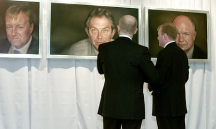 William Hague and Charles Kennedy look at portraits painted by Jonathan Yeo of themselves and Tony Blair.