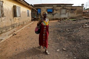 Ajayi walks through her neighbourhood as she makes her way to school