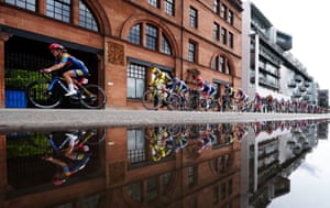 Cyclists on racing bikes beside some water
