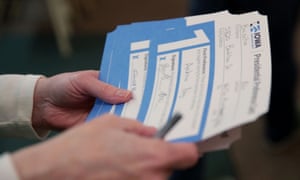 A precinct worker counts ballots in Iowa.