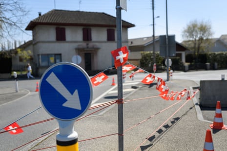 This picture taken on April 5, 2020 shows a border between Switzerland and France closed by concrete blocks and adorned with Swiss flags in Presinge near Geneva as the country remains in lockdown to curb the spread of the novel corona virus, COVID-19.