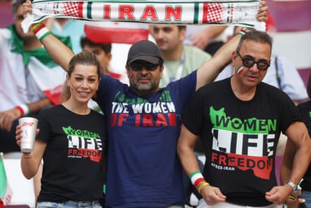 Iran fans wear T-shirts reading ‘Stand for the women of Iran’ and ‘Woman life freedom’ at a men’s World Cup match in 2022.