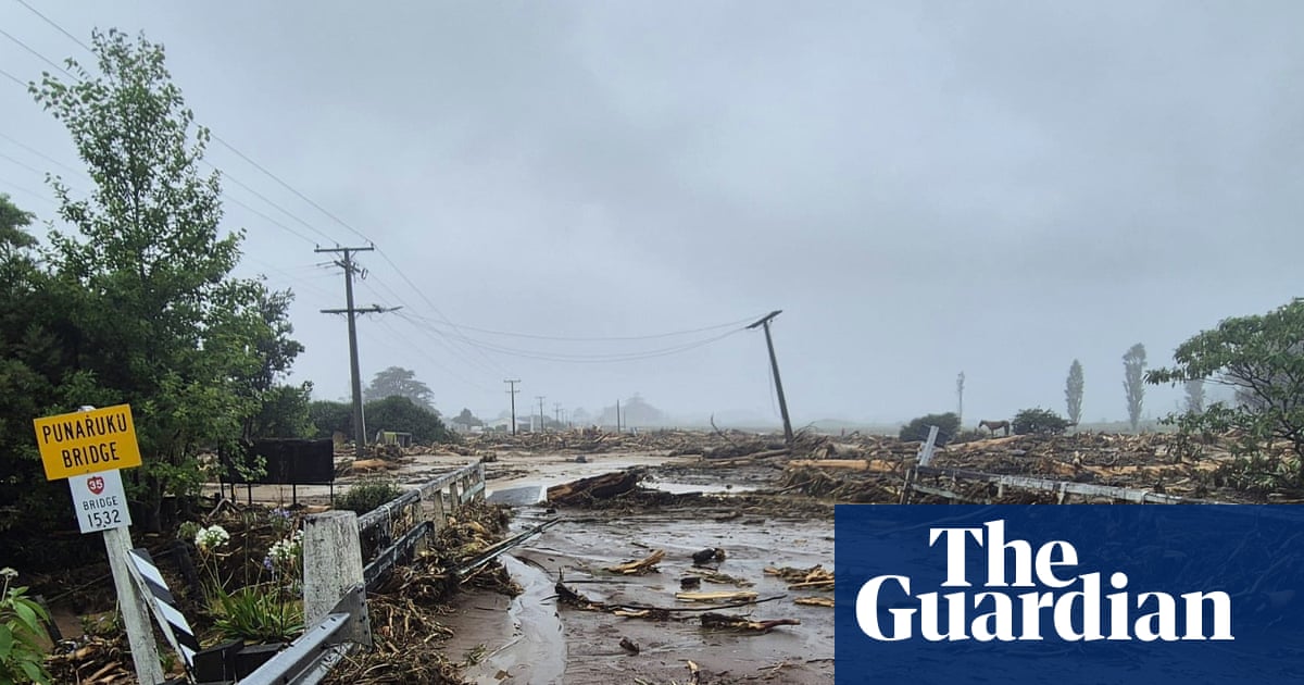 New Zealand storms: people missing after landslide hits campsite as minister compares east coast to war zone'