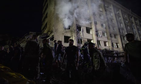 Rescues and volunteers work at the site of hotel and restaurant buildings heavily damaged by a Russian missile strike, amid Russia’s attack on Ukraine, in central Kramatorsk.