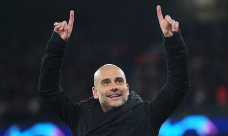 Pep Guardiola with both arms raised and index fingers pointing skyward