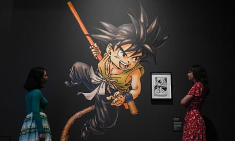 Museum employees pose next to an artwork from the manga series Dragon Ball by Toriyama Akira for the exhibition 'Manga' at the British Museum in 2019.