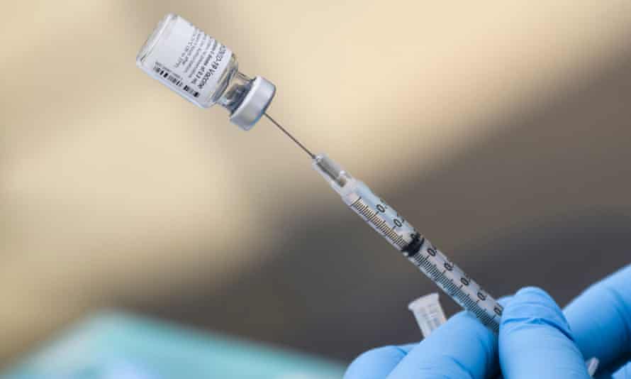 A syringe is filled with a first dose of the Pfizer Covid-19 vaccine at a mobile vaccination clinic in Los Angeles, California.