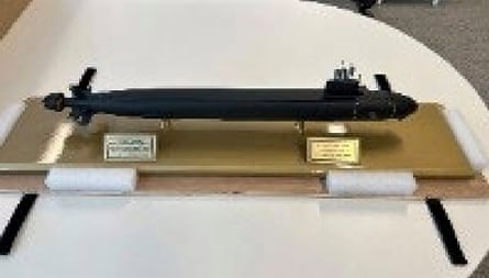 The model submarine sits on a golden base with two engraved plates installed on the base